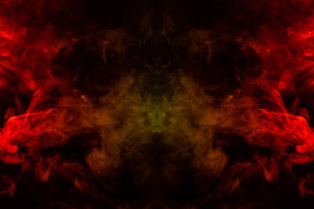 Smoke of different orange and red colors in the form of horror in the shape of the head, face and...