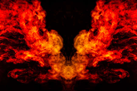 Smoke of different orange and red colors in the form of horror in the shape of the head, face and...