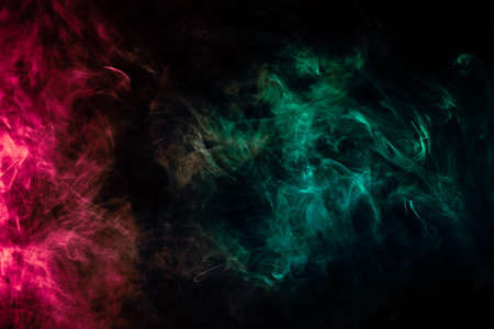 Beautiful column of smoke in the neon bright light of red, green, pink and turquoise on a black...