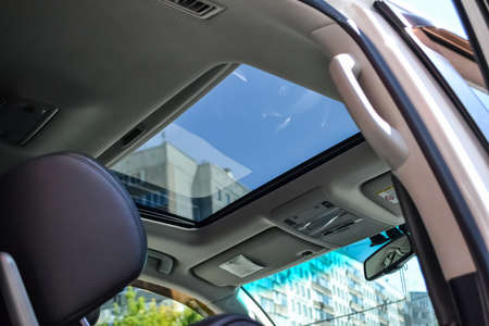 View of the ceiling of the car with a transparent glass hatch for airing, opening so that you can...