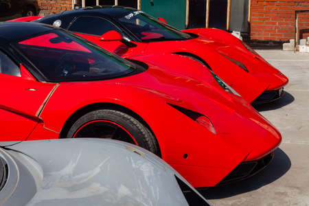 Novosibirsk, Russia - 06.12.2019: Two cars Marussia Motors model B1 in red color and black roof and...