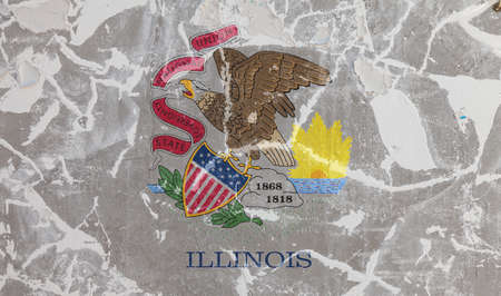 The national flag of the US state Illinois in against a gray wall with cracks and faults on the day of independence in color of white and yellow. Political and religious disputes, customs and deliveryの写真素材