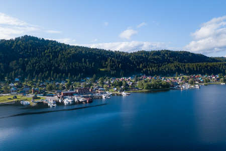 Aerial view of the pier in the Teletskoye lake with ships, ships and boats moored to the coast near the village of Artybash on a sunny summer day. Rest and travel to the nature reserve.の写真素材