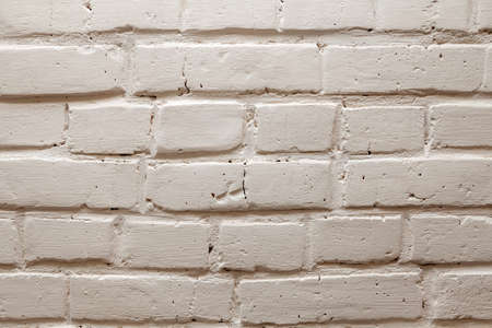 The background is made of yellow, white or gray bricks with a wavy relief, cracks, holes and...
