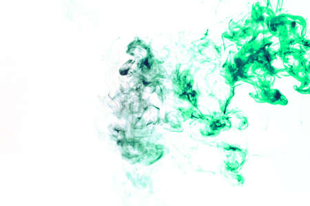 Colored background with winding clouds of smoke from patterns of different forms of red, green colors with tongues of flame on a white isolated background as ink or poisonの写真素材