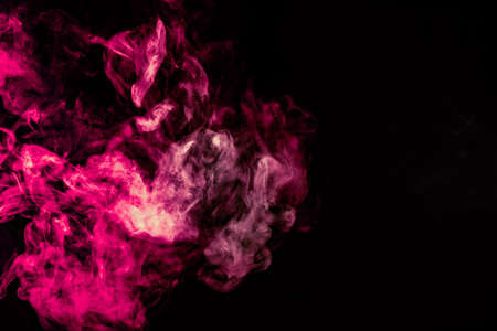 Colored background with winding clouds of smoke from patterns of different forms of pink, green and blue colors with tongues of flame on a black isolated backgroundの写真素材