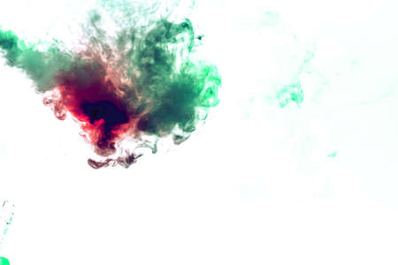 Colored background with winding clouds of smoke from patterns of different forms of red, green colors with tongues of flame on a white isolated background as ink or poisonの写真素材