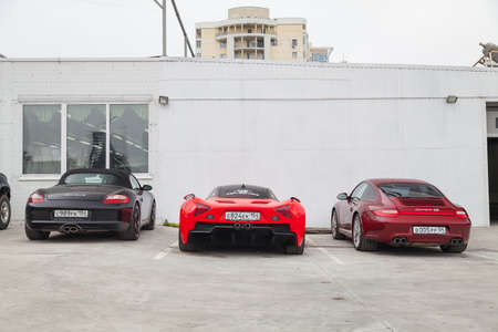 Novosibirsk, Russia - 07.17.2019: Three cars Marussia Motors model B1, Porsche Boxster and Carrera...