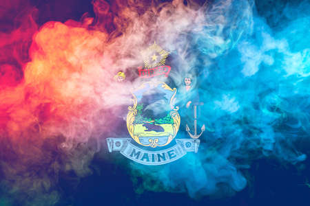The national flag of the US state Maine in against a gray smoke on the day of independence in...