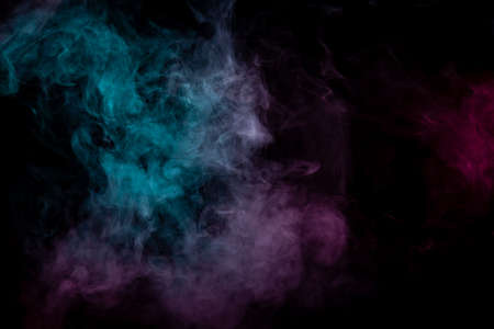 Colored background with winding clouds of smoke from patterns of different forms of pink, green and blue colors with tongues of flame on a black isolated background. Print for t-shirt.の写真素材