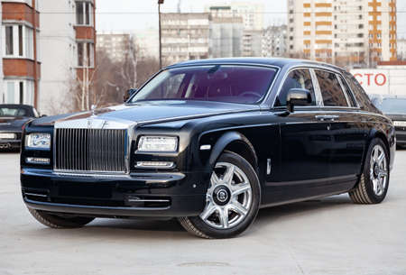 Novosibirsk, Russia - 07.25.2019: Front side view of new a very expensive luxury Rolls Royce Phantom car, a long black limousine, model outdoors, prepared for saleのeditorial素材