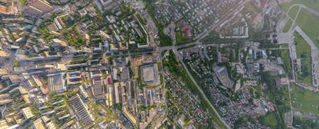 Panoramic aerial view of the city with tall buildings and a shopping center in the middle in...