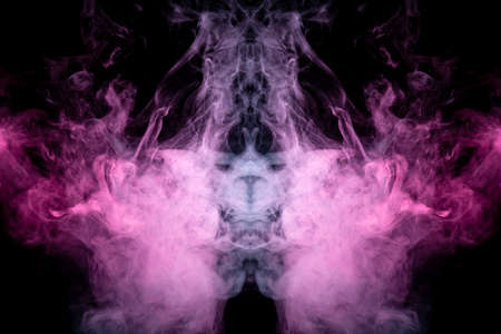 Smoke of different blue, red and pink colors in form of horror in the shape of the head, face and eye with wings on a black isolated background. Soul and ghost in mystical symbol. Print for clothes.の写真素材