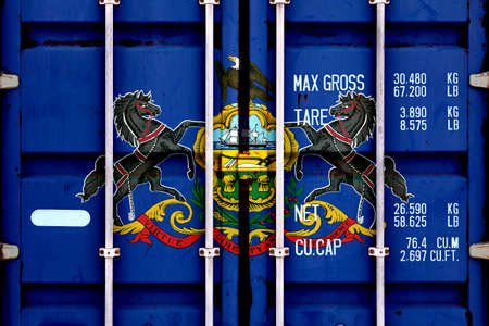 The national flag of the US state Pennsylvania in a container doors on the day of independence in...