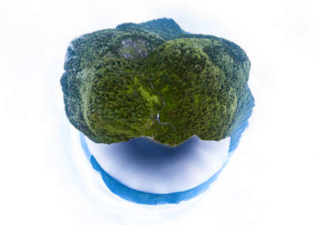 Abstract image of an island with green trees and mountains near the ocean or lake in Altai mountains in the form of a globe, planet or headの写真素材