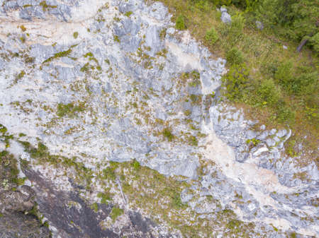 landscape of the valley of a mountain hill flooded with light and covered with large stones of...