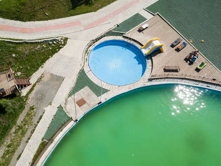 Aerial view of a tourist recreation center with a children's pool with blue clear water, an...