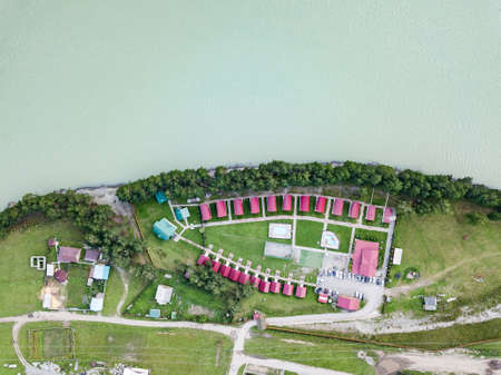 Identical houses on the banks of the river for relaxing during holidays and travel. Tourist...