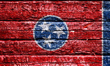 The national flag of the US state Tennessee in against a black charred wooden wall on the day of independence. Political and religious disputes, fire department and firefighters.の写真素材