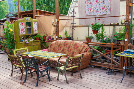 Cafe or restaurant interior in retro vintage style with colored old things sofa and chairs in the...
