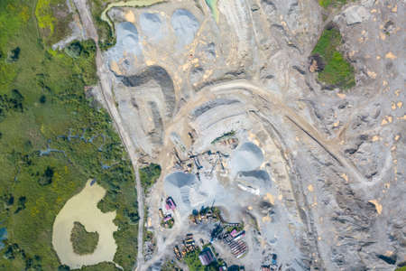Aerial view of a small plant for the production and cleaning rubble and cement near the heaps of...