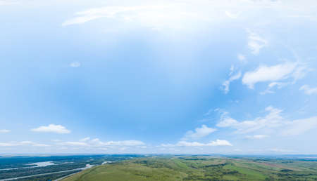 Aerial view 180 degree of beautiful picturesque landscape with panoramic deep sky with clouds, natural green fields and meadows.の写真素材
