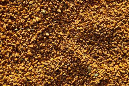 Background of small yellow decorative stones lying on the ground in the garden for decoration....