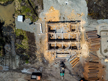 Aerial view of the construction site during the building of a wooden house from thick beams of sawn...