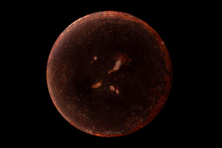 Abstract image of planet Venus from the surface of an old griddle on a black background in space.の写真素材