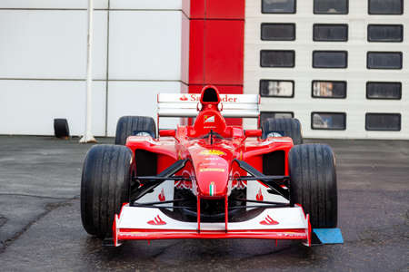 Novosibirsk, Russia - 11.01.2019: Red Ferrari racing sports cars for Formula 1 on the street near the garage box.のeditorial素材