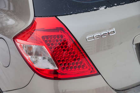 Novosibirsk, Russia - 11.21.2019: Beige Kia Ceed rear taillamp view on the car parking with snow...