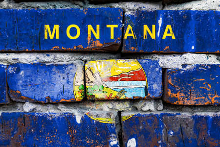 Montana grunge, damaged, scratch, old style united states flag on brick wall.の写真素材