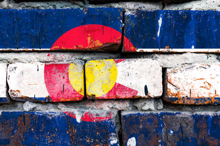 Colorado grunge, damaged, scratch, old style united states flag on brick wall.の写真素材