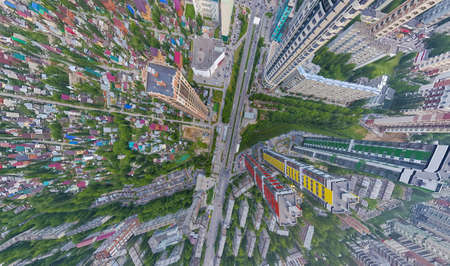 Abstract aerial view of square in the city with traffic, streets and a lot of tall colored buildings...