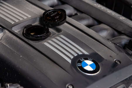 Novosibirsk, Russia - 12.25.2019: BMW car engine with emblem and open engine filler neck for topping up oil due to malfunction and high consumption and combustion.のeditorial素材