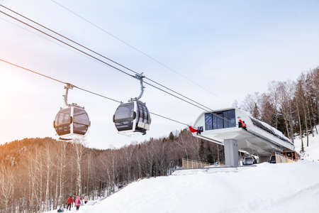 Upper passenger disembarkation point of a gondola cableway with a booth suspended on a rope on a...