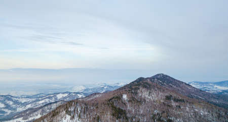 Picturesque landscape in the Altai mountains with snow-capped peaks under a blue sky with clouds in...
