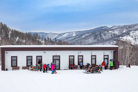 Altai, Russia - 01.01.2020: Building with rental of ski equipment and snowboards in the sports tourist base Turquoise Katun. Seasonal sports.のeditorial素材