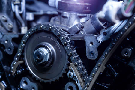 Gear, chain drive shaft in conveyor, belt is on production line. Timing chain of car, tensioners in...