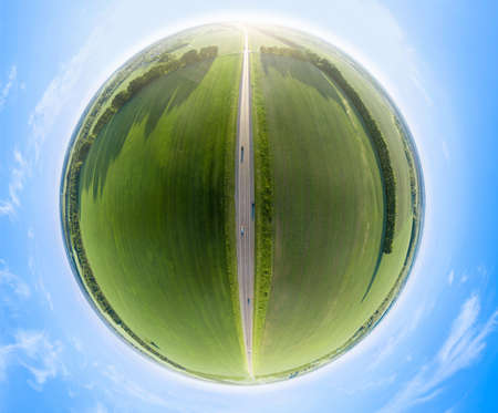 Aerial view of green fields under a blue sky with clouds in a summer day. Full VR 360 Degree Aerial...