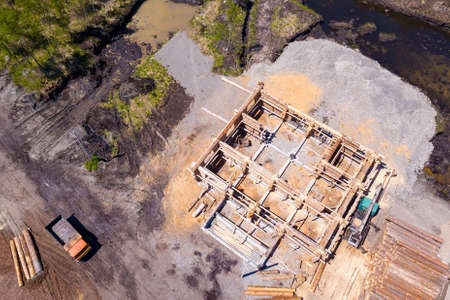 Aerial view of the construction site during the building of a wooden house from thick beams of sawn...