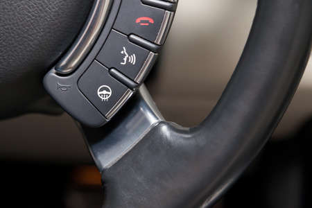 Close-up on a part of the interior of a modern luxury car with a view of the heated steering wheelの写真素材