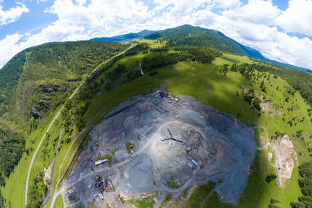Aerial view of a small plant for the production and cleaning rubble and cement near the heaps of building materials, the tractors and trucks transports the finished product. Mining in quarry.の写真素材