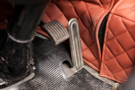 Gas pedals and brakes in a truck on the floor with a rubber mat. The concept of developing and accelerating a business or its braking by management.の写真素材