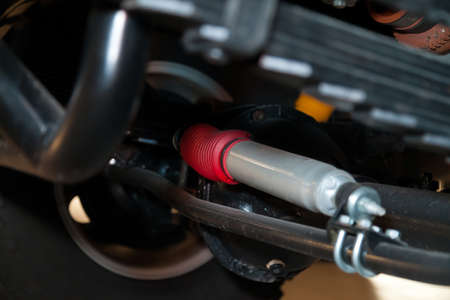 View of the bottom of the car with enhanced suspension and steering damper for off-road driving and...