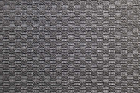 Seamless textile black checkered fabric material. Dark color background with squares.
