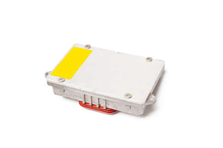 Plastic car engine control unit with metal elements on a white isolated background is the connecting...