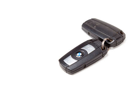 Key BMW brand keychain with chip - central locking control panel with dynamic code isolated on a white background in a photo studio. Old key from a German car at an auto-parsing.のeditorial素材