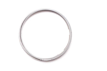 Metal chromed piston rings for car engine repair on a white isolated background in a photo studio....