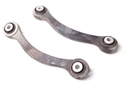 A pair of aluminum levers of the car chassis on a white isolated background in a photo studio, a...